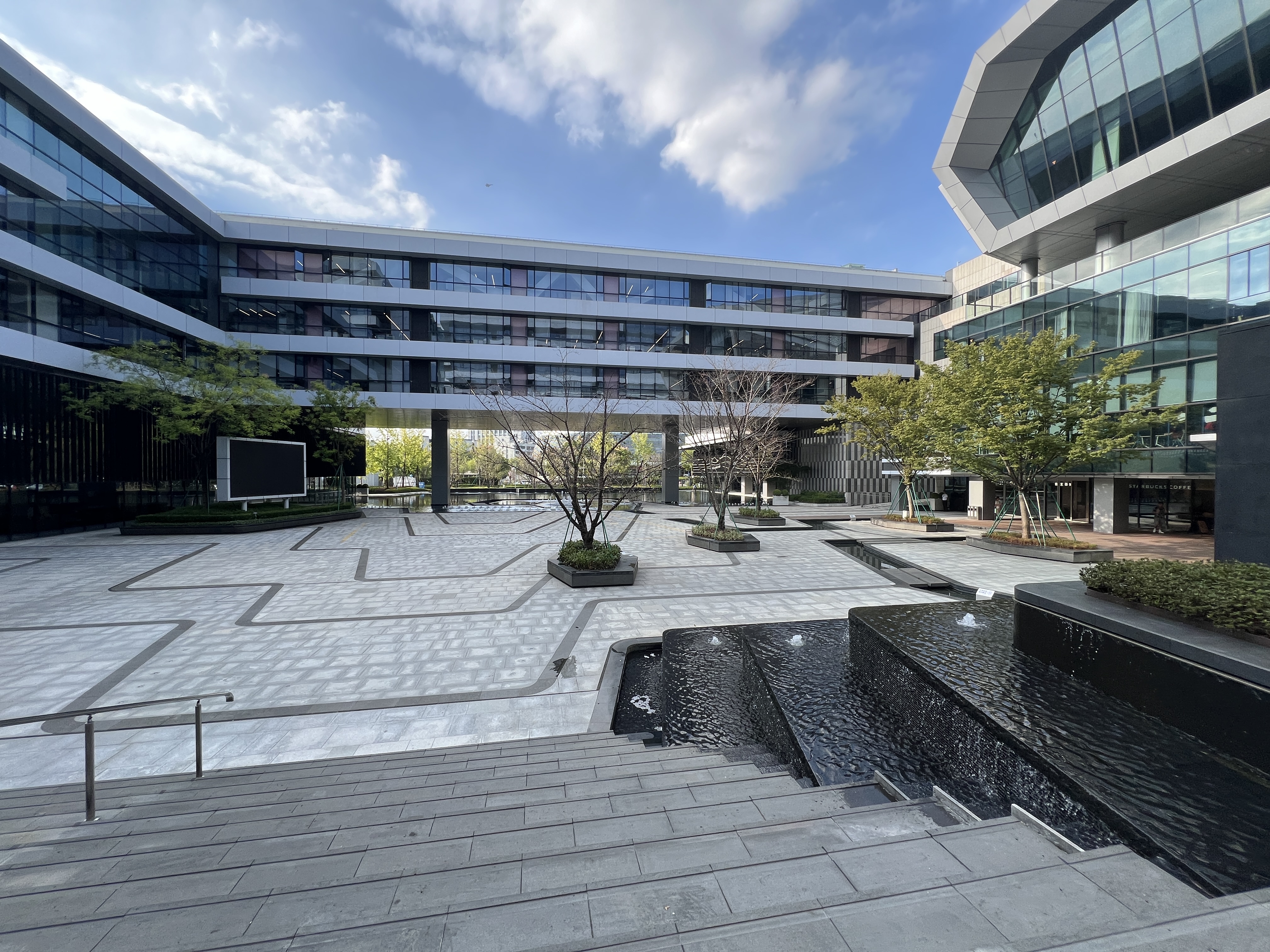 Ant Group HQ with flowing water / The Once Times